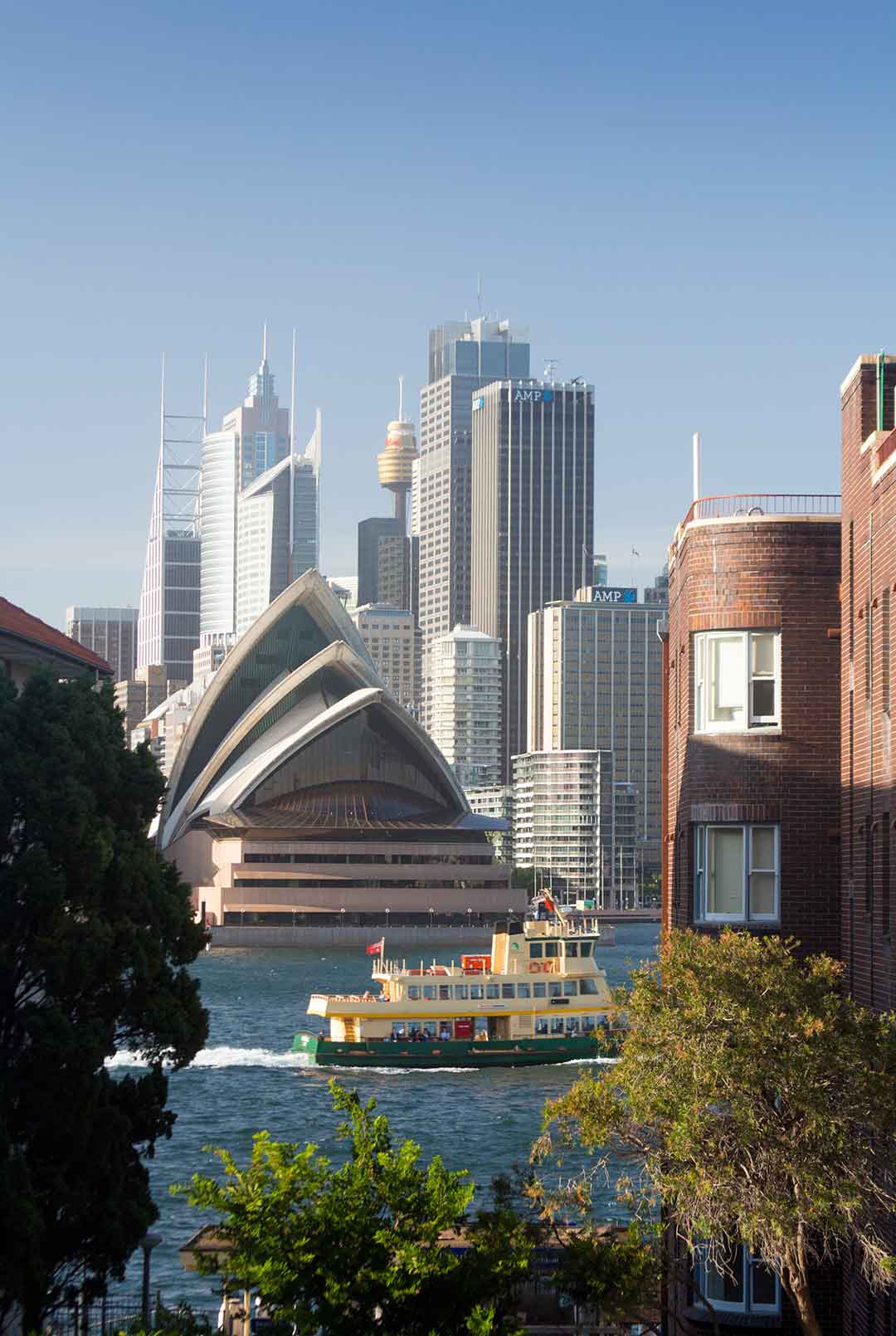 Image of ferry passing Sydney Opera House, seen from Kirribilli